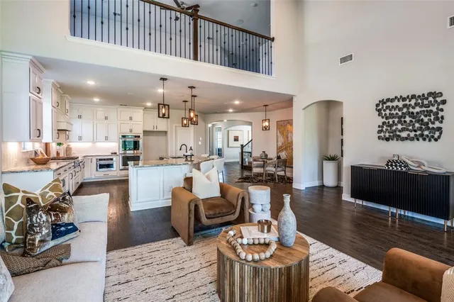 a living room with furniture and view of kitchen