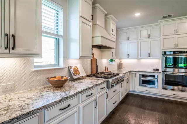 a kitchen with lot of counter space and wooden floor