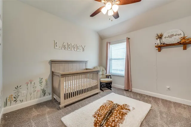a kids room with a bed and a chandelier
