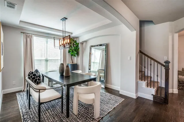 a dining room with furniture window and wooden floor