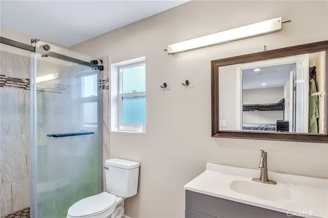 a bathroom with a toilet sink and shower