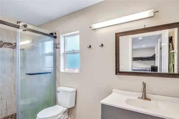 a bathroom with a toilet sink and shower