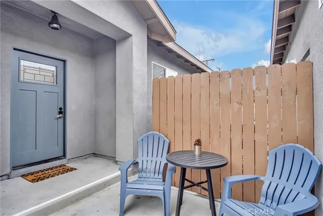 a view of a bedroom with furniture and window