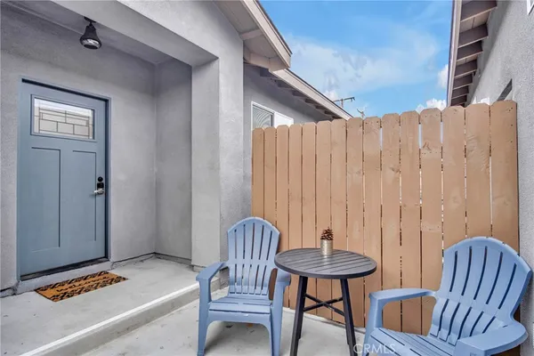 a view of a bedroom with furniture and window