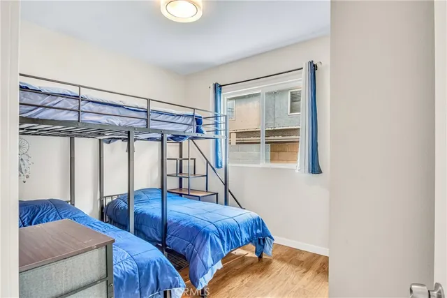 a bedroom with two beds and a window