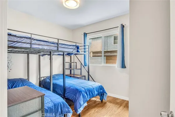 a bedroom with two beds and a window