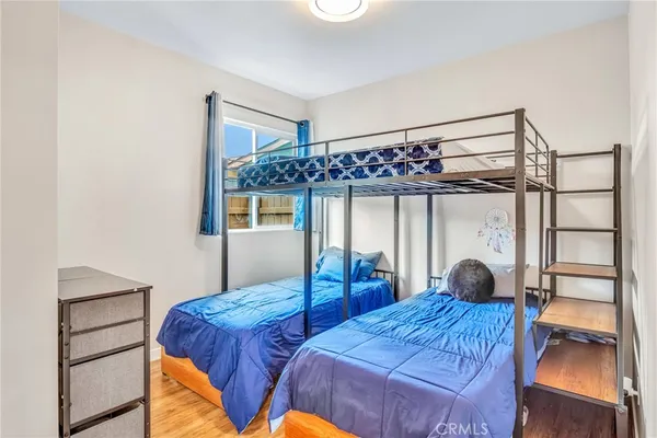 a bedroom with a large bed and a chandelier