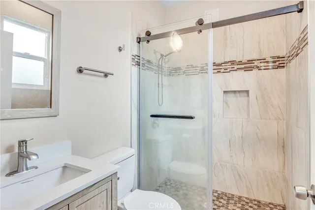 a bathroom with a sink toilet and shower