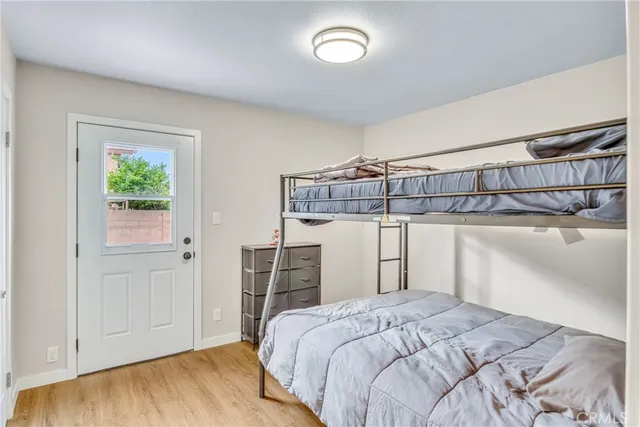 a bedroom with a bed and wooden floor