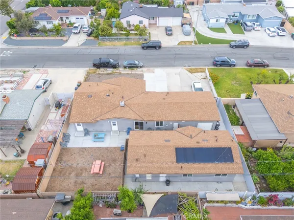 an aerial view of residential houses with outdoor space and parking