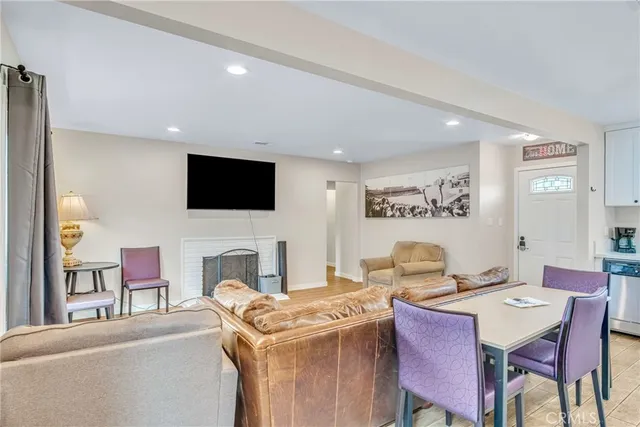 a living room with a couch a dining table and a flat screen tv