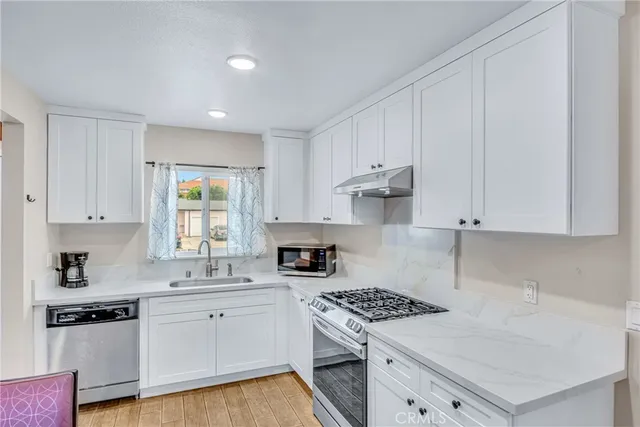 a kitchen with a stove a sink and a refrigerator