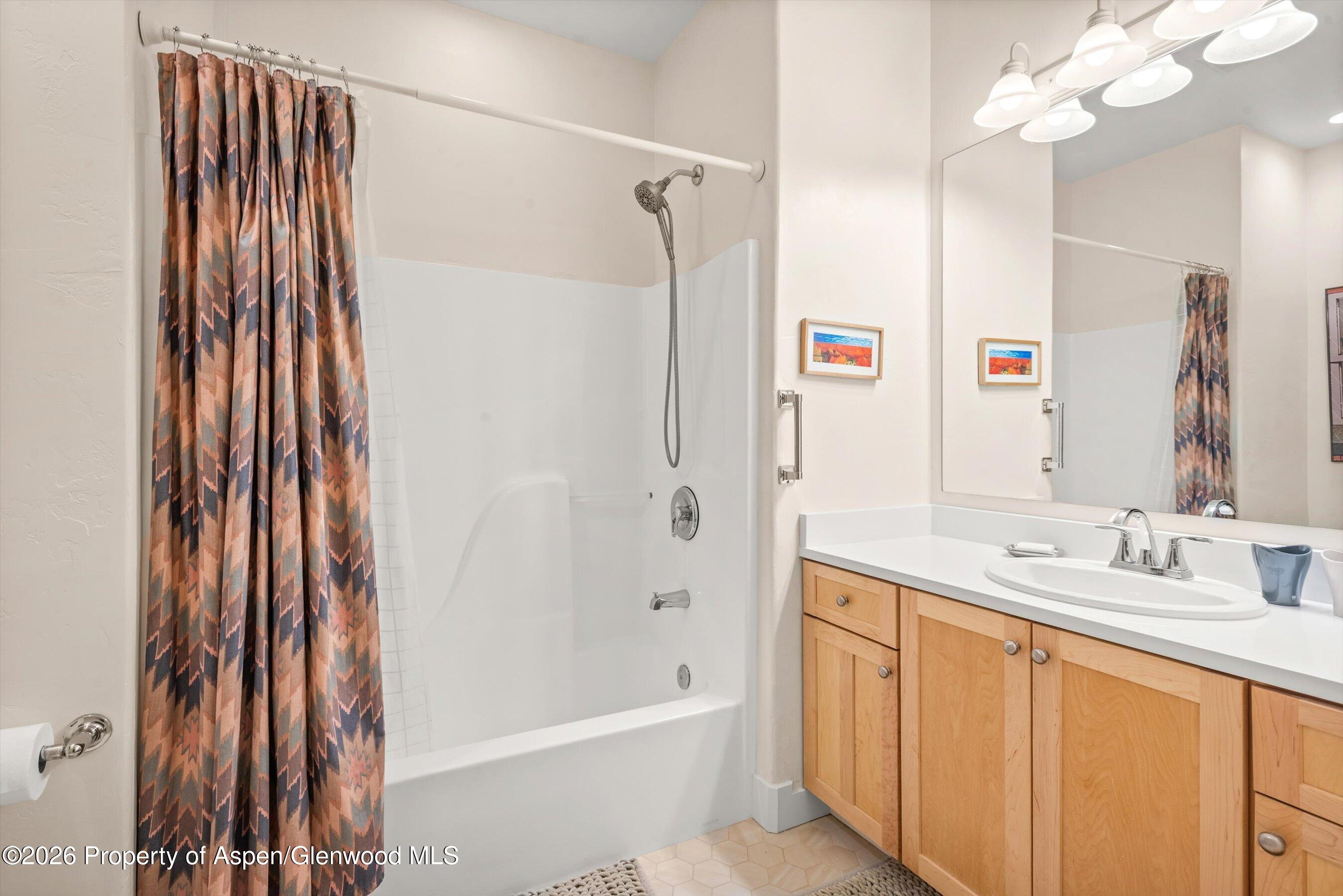 546 Evans Court Basalt, CO 81621 - Photo 11 of 13 a bathroom with a bathtub a sink and a mirror