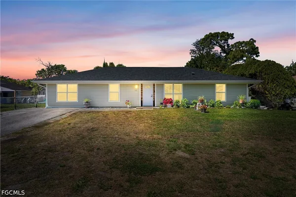 a front view of house with yard and outdoor seating
