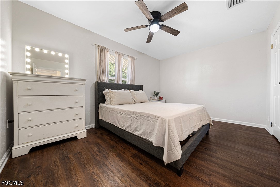 2335 50th Terrace Southwest Naples, FL 34116 - Photo 14 of 26 a bed room with a bed and a ceiling fan
