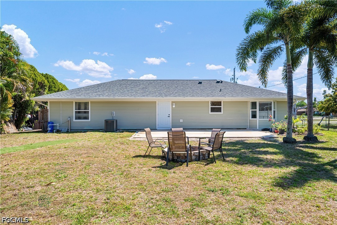 2335 50th Terrace Southwest Naples, FL 34116 - Photo 19 of 26 a backyard of a house with table and chairs
