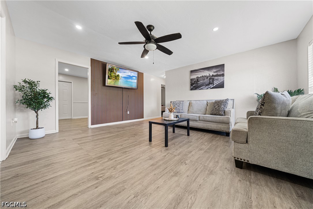 2335 50th Terrace Southwest Naples, FL 34116 - Photo 2 of 26 a living room with furniture and a wooden floor