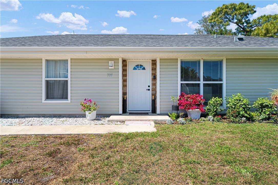 2335 50th Terrace Southwest Naples, FL 34116 - Photo 21 of 26 a front view of a house with flowers