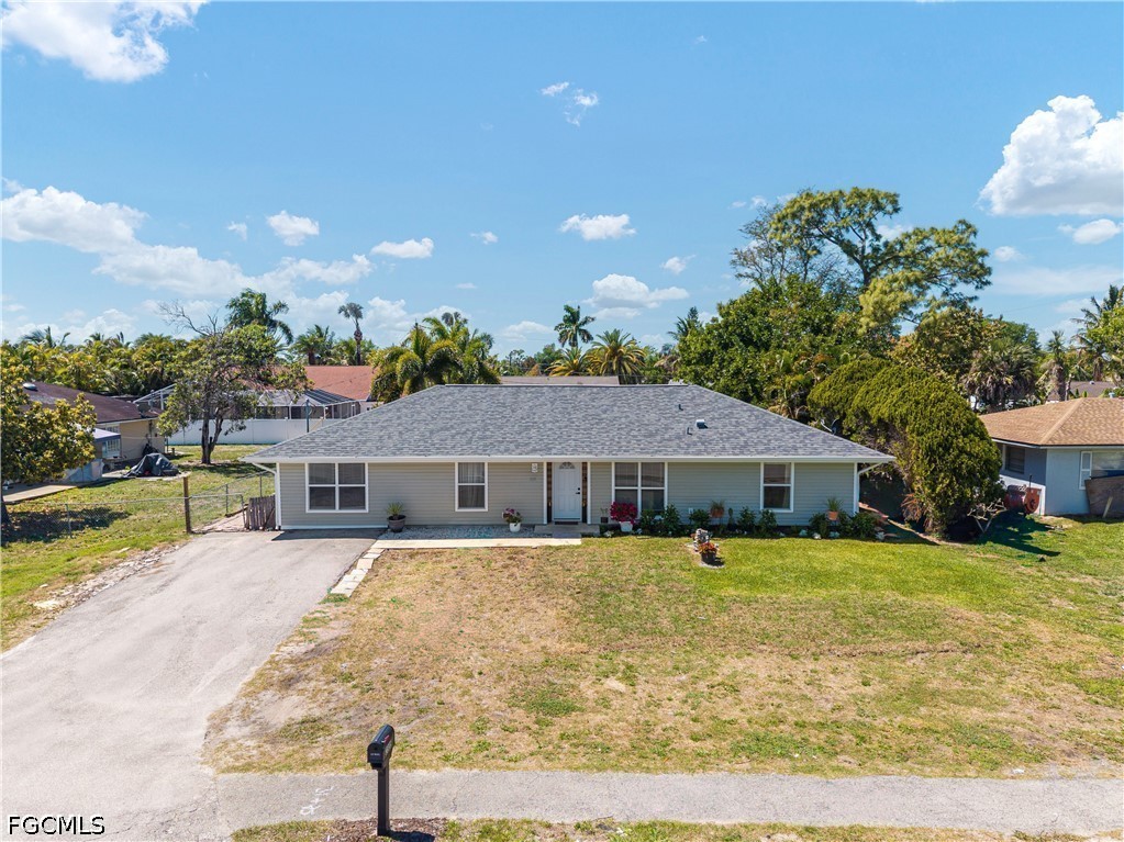 2335 50th Terrace Southwest Naples, FL 34116 - Photo 22 of 26 a view of a house with a big yard and potted plants