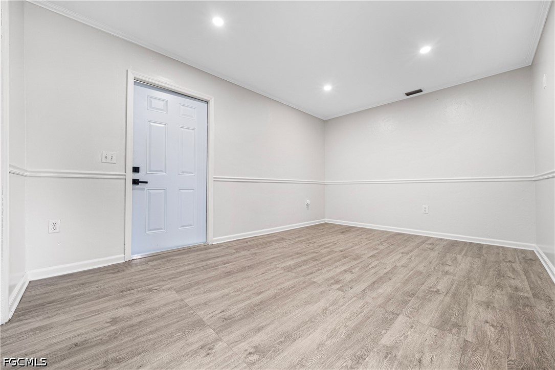 2335 50th Terrace Southwest Naples, FL 34116 - Photo 7 of 26 wooden floor in an empty room