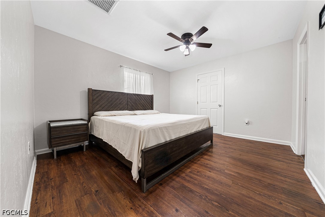 2335 50th Terrace Southwest Naples, FL 34116 - Photo 8 of 26 a bedroom with a bed and wooden floor