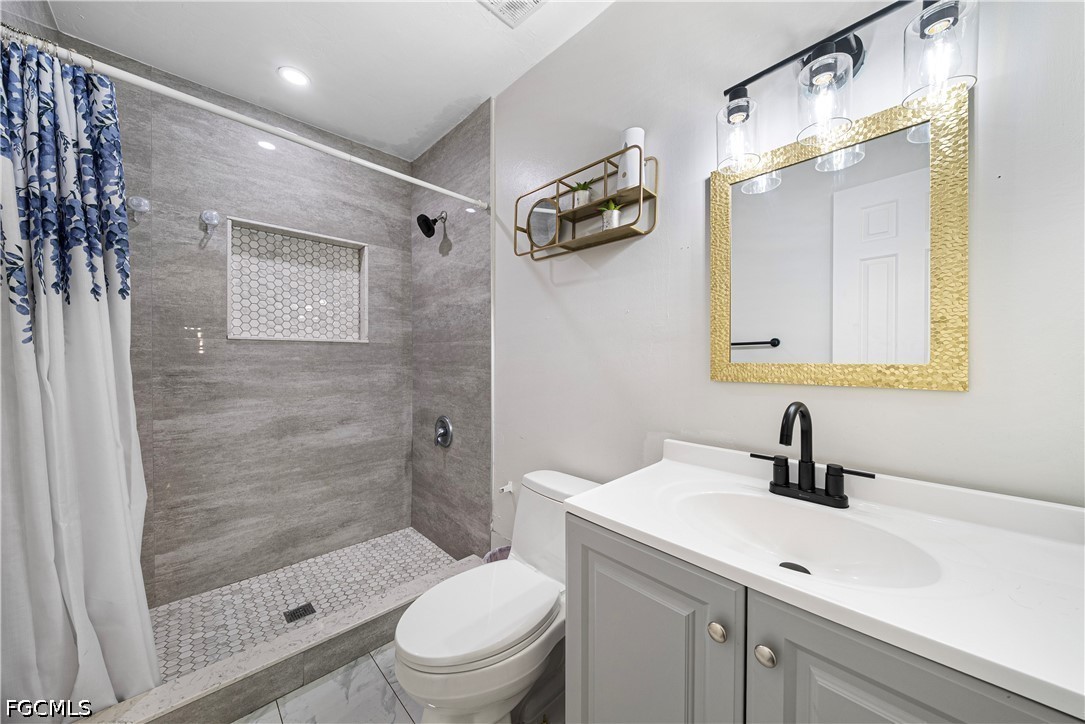 2335 50th Terrace Southwest Naples, FL 34116 - Photo 9 of 26 a bathroom with a sink a toilet and shower