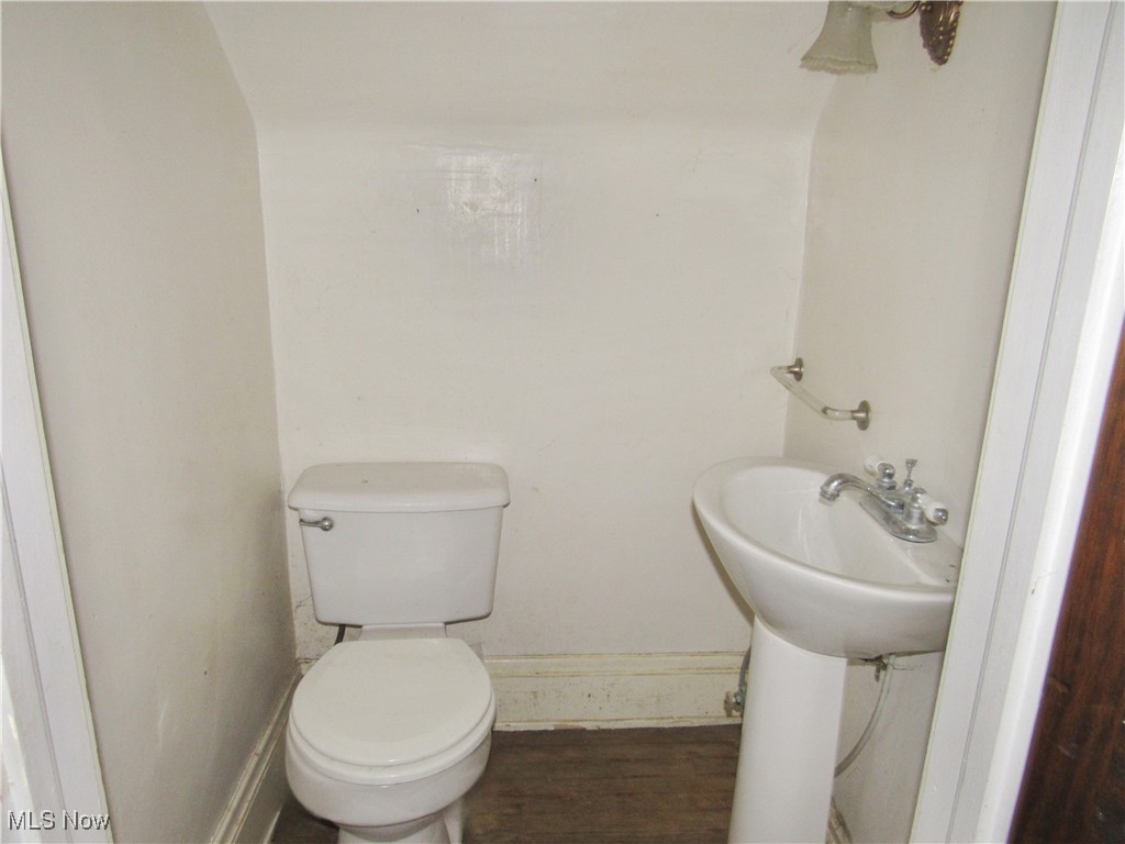 14450 Superior Road Cleveland, OH 44118 - Photo 13 of 35 Half bath featuring toilet, wood finished floors, and baseboards