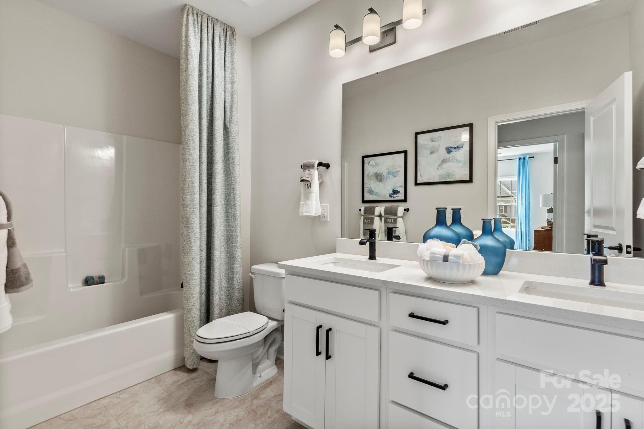 13408 Chopin Ridge Road Huntersville, NC 28078 - Photo 18 of 22 a bathroom with a sink a toilet and a mirror