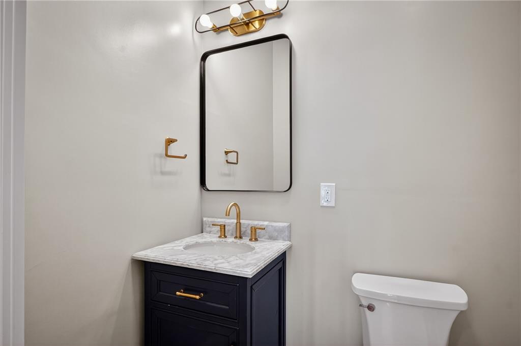 10390 Meinert Road Wexford, PA 15090 - Photo 16 of 42 a bathroom with a granite countertop sink a toilet and mirror