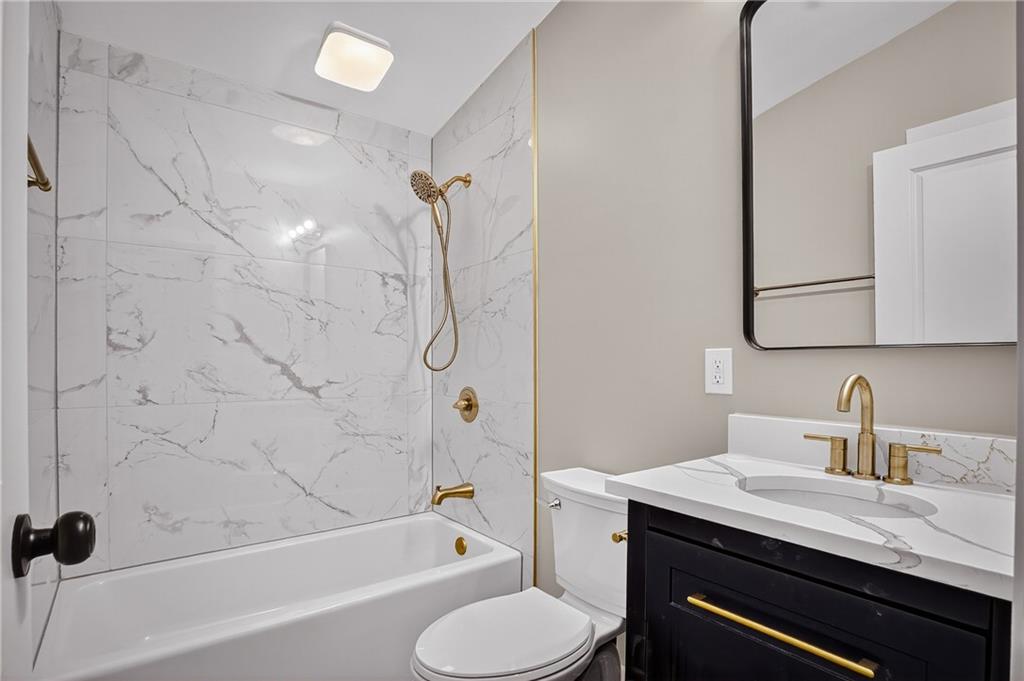 10390 Meinert Road Wexford, PA 15090 - Photo 24 of 42 a bathroom with a granite countertop sink toilet a mirror and shower