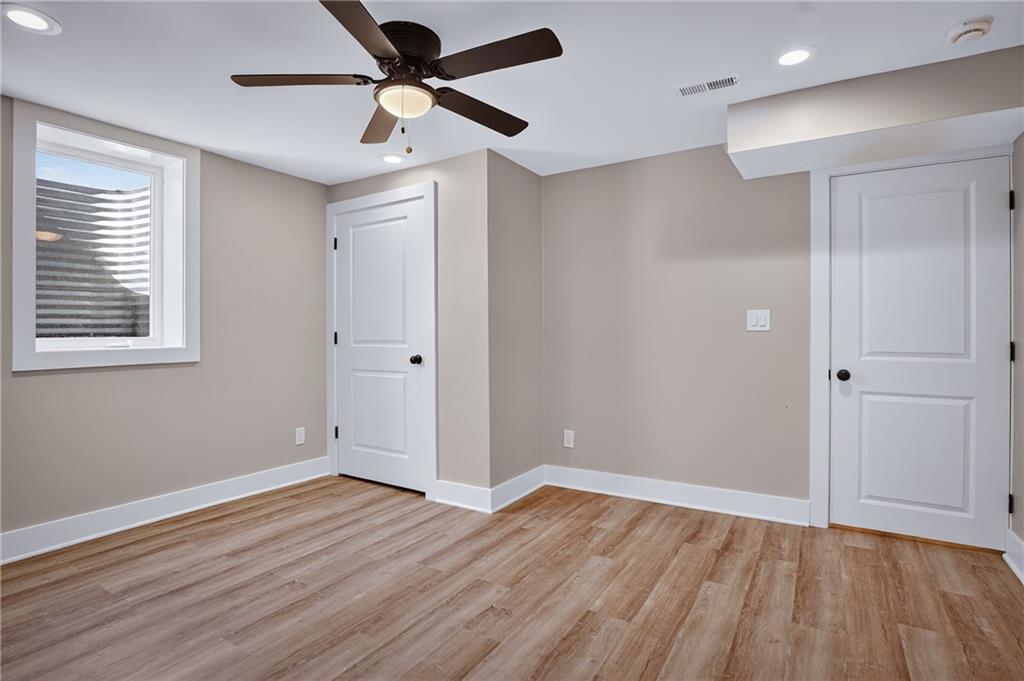 10390 Meinert Road Wexford, PA 15090 - Photo 31 of 42 an empty room with wooden floor a ceiling fan and windows