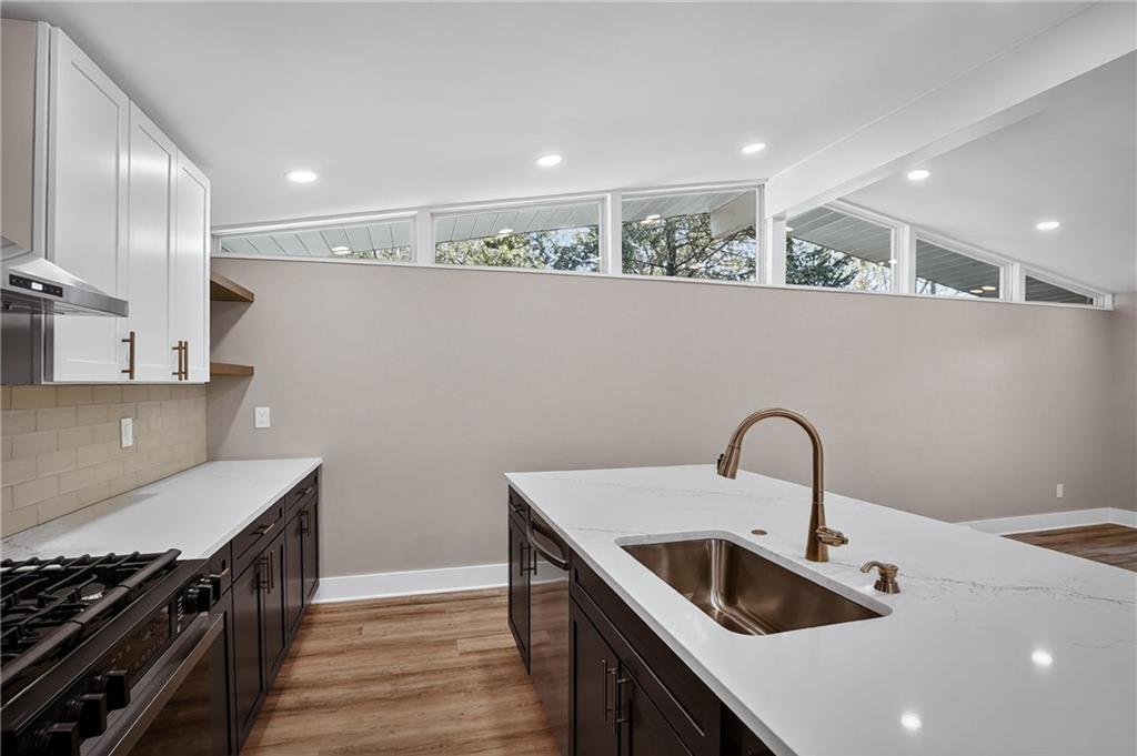 10390 Meinert Road Wexford, PA 15090 - Photo 7 of 42 a kitchen with a sink a stove and kitchen island with wooden floor