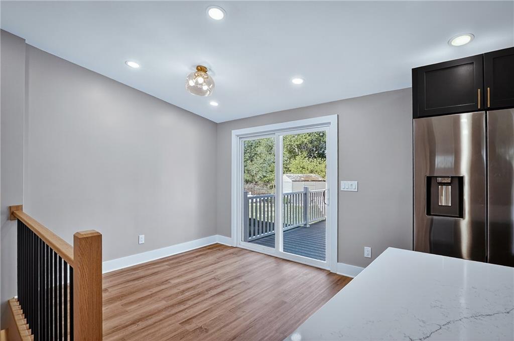 10390 Meinert Road Wexford, PA 15090 - Photo 10 of 42 a very nice looking room with wooden floor and a kitchen