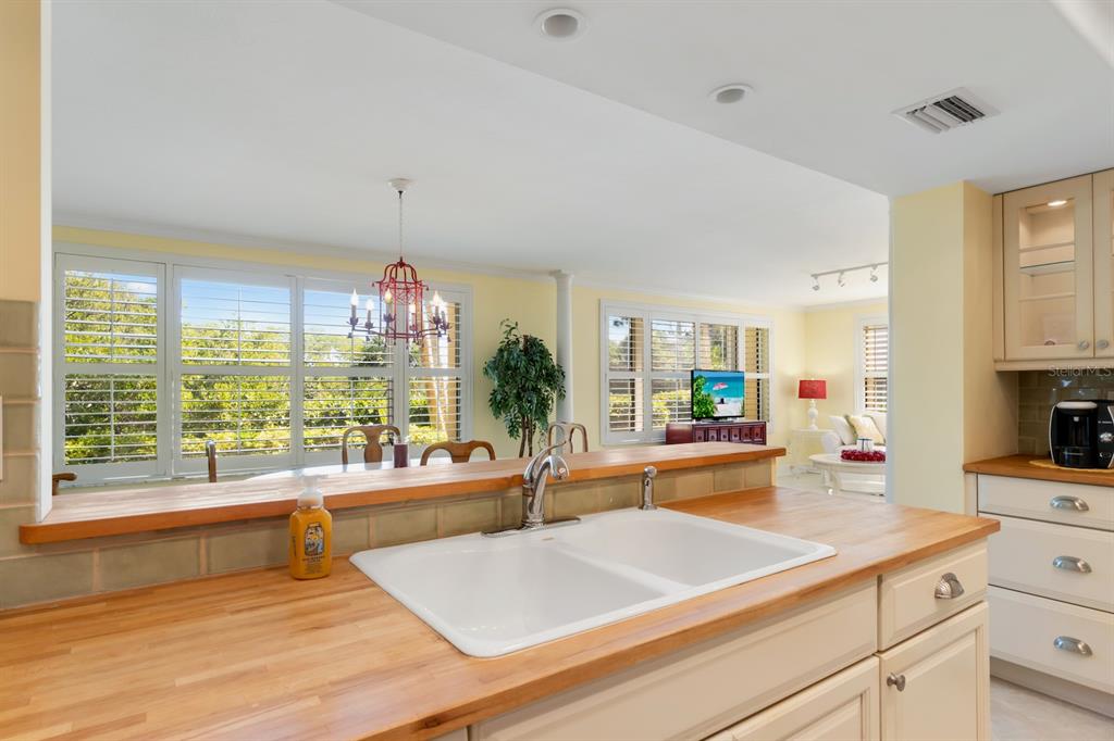 8767 Midnight Pass Road, Unit 101F Sarasota, FL 34242 - Photo 11 of 63 a living room with stainless steel appliances kitchen island furniture and a large window