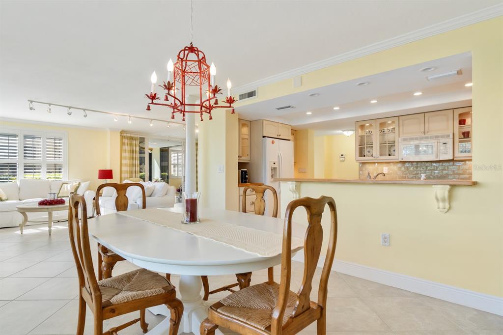 8767 Midnight Pass Road, Unit 101F Sarasota, FL 34242 - Photo 14 of 63 a view of a dining room with furniture and wooden floor