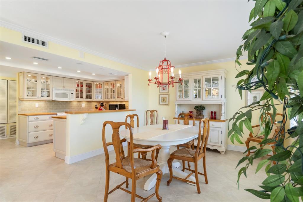 8767 Midnight Pass Road, Unit 101F Sarasota, FL 34242 - Photo 15 of 63 a dining room with furniture and a kitchen view