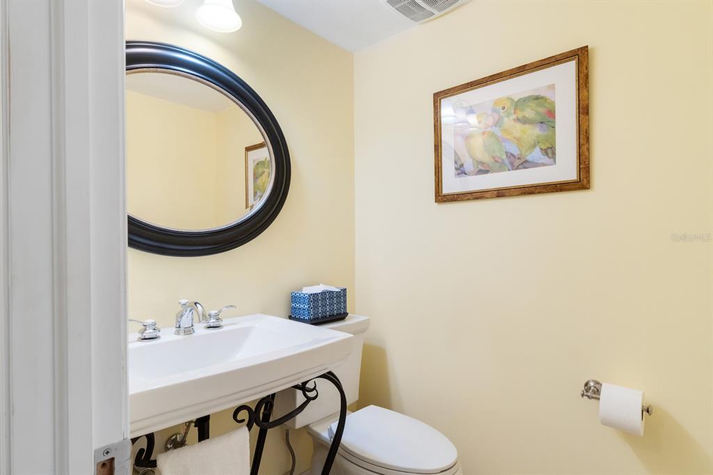 8767 Midnight Pass Road, Unit 101F Sarasota, FL 34242 - Photo 26 of 63 a bathroom with a sink and a mirror