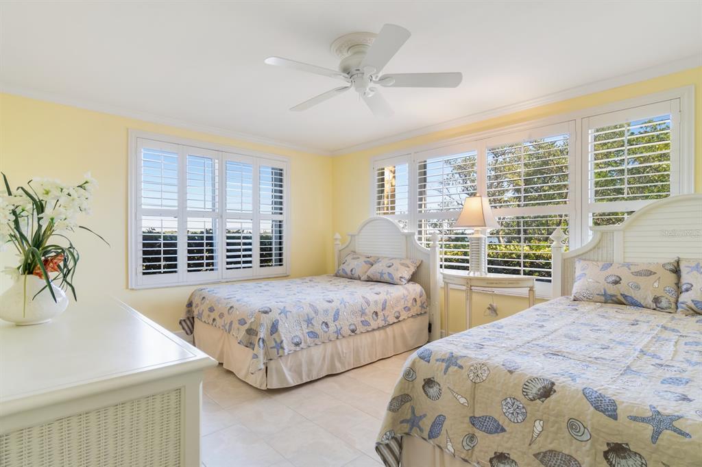 8767 Midnight Pass Road, Unit 101F Sarasota, FL 34242 - Photo 27 of 63 a bedroom with two beds and a large window