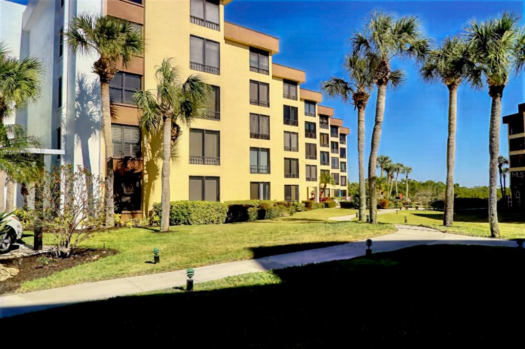 8767 Midnight Pass Road, Unit 101F Sarasota, FL 34242 - Photo 35 of 63 a view of a building with a yard
