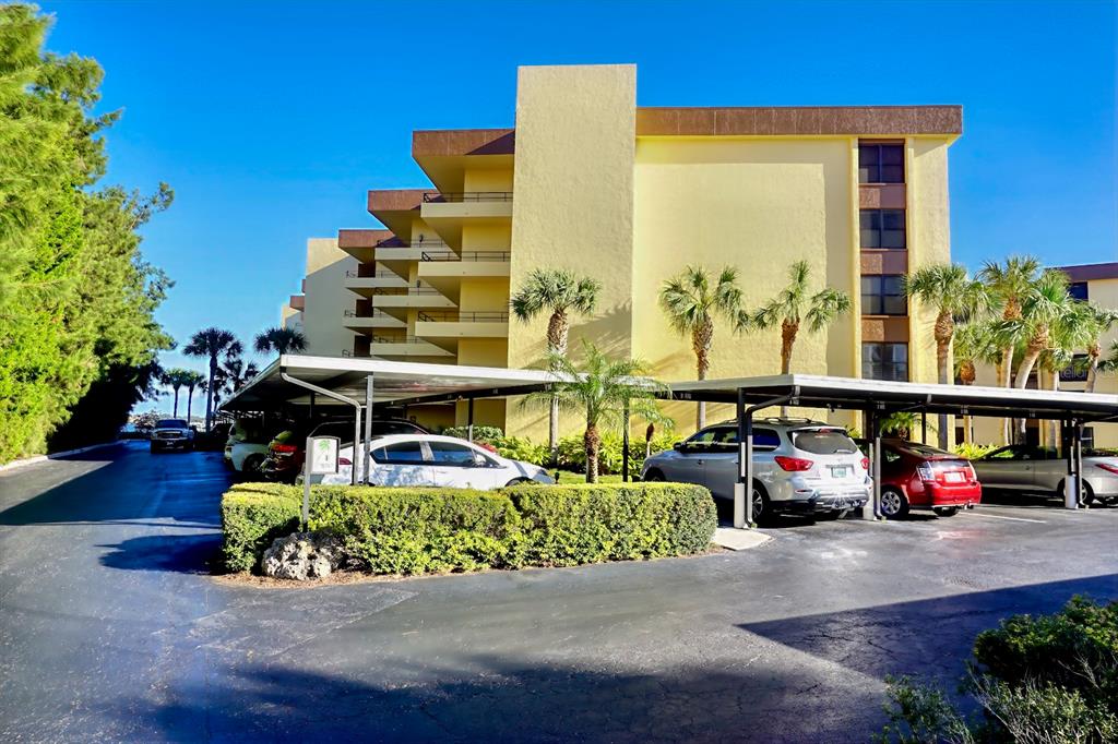 8767 Midnight Pass Road, Unit 101F Sarasota, FL 34242 - Photo 36 of 63 a front view of a house with outdoor seating