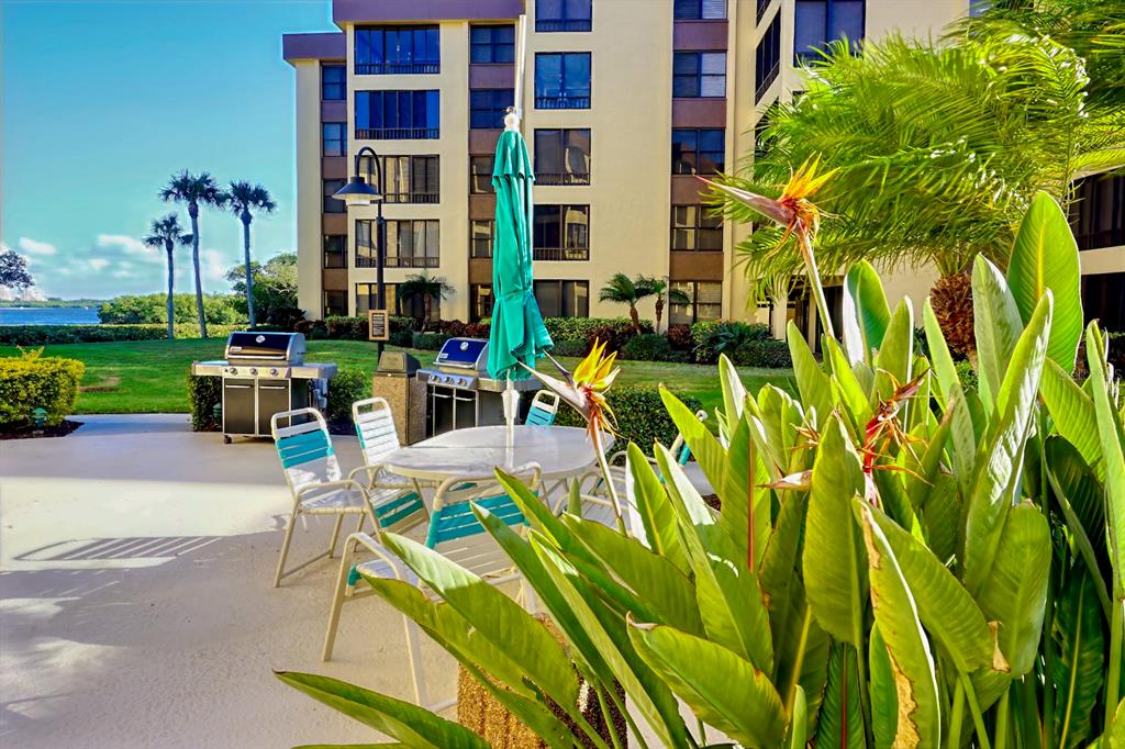 8767 Midnight Pass Road, Unit 101F Sarasota, FL 34242 - Photo 37 of 63 a view of backyard of house with outdoor seating and green space