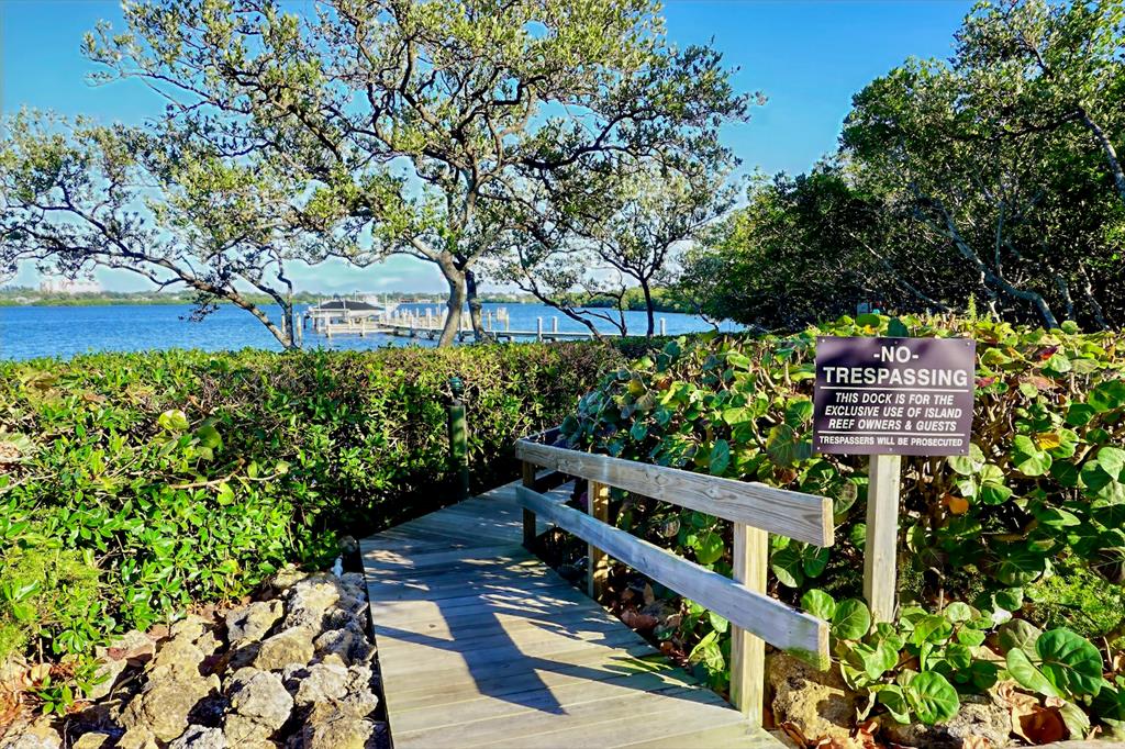 8767 Midnight Pass Road, Unit 101F Sarasota, FL 34242 - Photo 39 of 63 a view of a bench in a garden