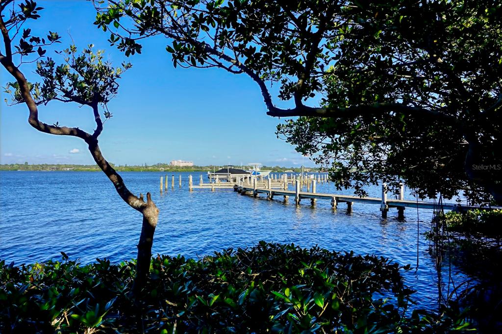 8767 Midnight Pass Road, Unit 101F Sarasota, FL 34242 - Photo 41 of 63 a view of house with outdoor seating and flowers