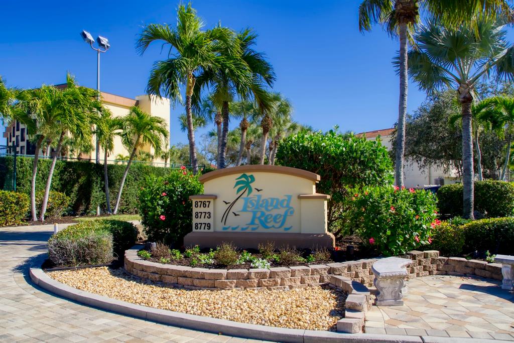 8767 Midnight Pass Road, Unit 101F Sarasota, FL 34242 - Photo 55 of 63 a view of a backyard with plants and palm tree