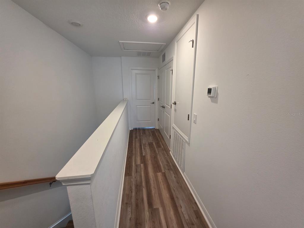 3318 Composition Street Kissimmee, FL 34758 - Photo 13 of 28 a view of a hallway with wooden floor