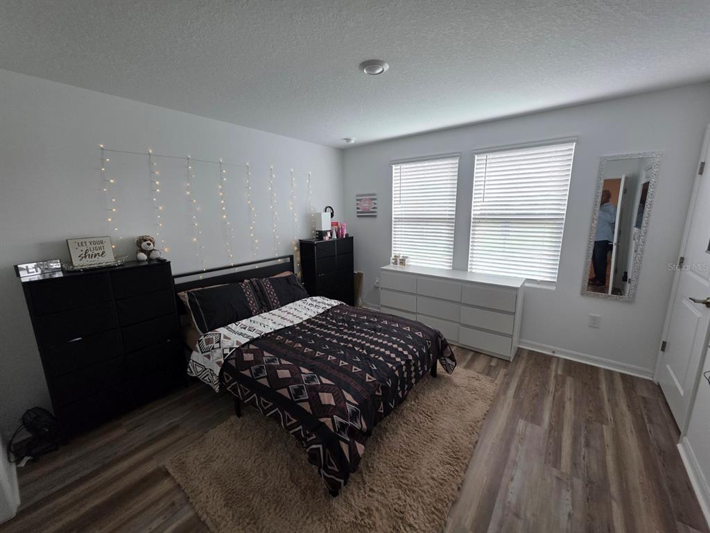 3318 Composition Street Kissimmee, FL 34758 - Photo 14 of 28 a bedroom with a bed and wooden floor