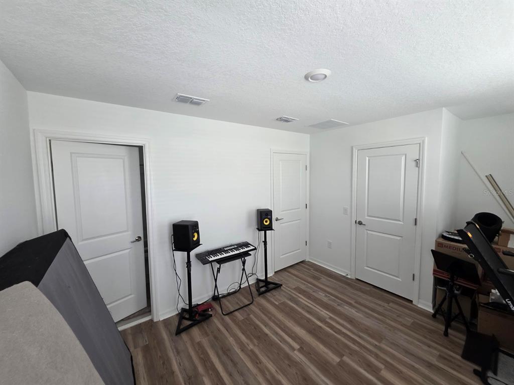 3318 Composition Street Kissimmee, FL 34758 - Photo 19 of 28 a view of a room with wooden floor and furniture