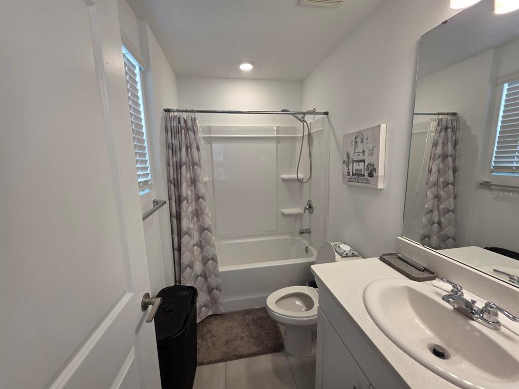 3318 Composition Street Kissimmee, FL 34758 - Photo 20 of 28 a bathroom with a sink a toilet and shower