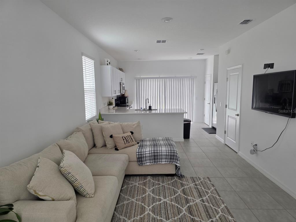 3318 Composition Street Kissimmee, FL 34758 - Photo 2 of 28 a living room with furniture and a flat screen tv