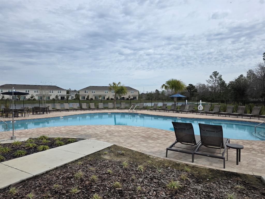 3318 Composition Street Kissimmee, FL 34758 - Photo 25 of 28 a view of a lake with a terrace